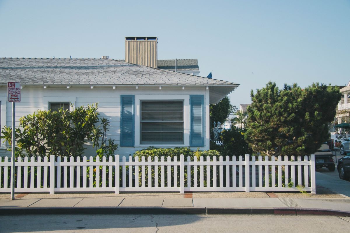 A photo of an Anaheim residence with a white picket vinyl fence around the yard.