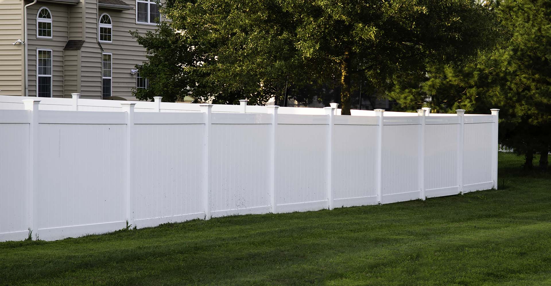 A white vinyl fence