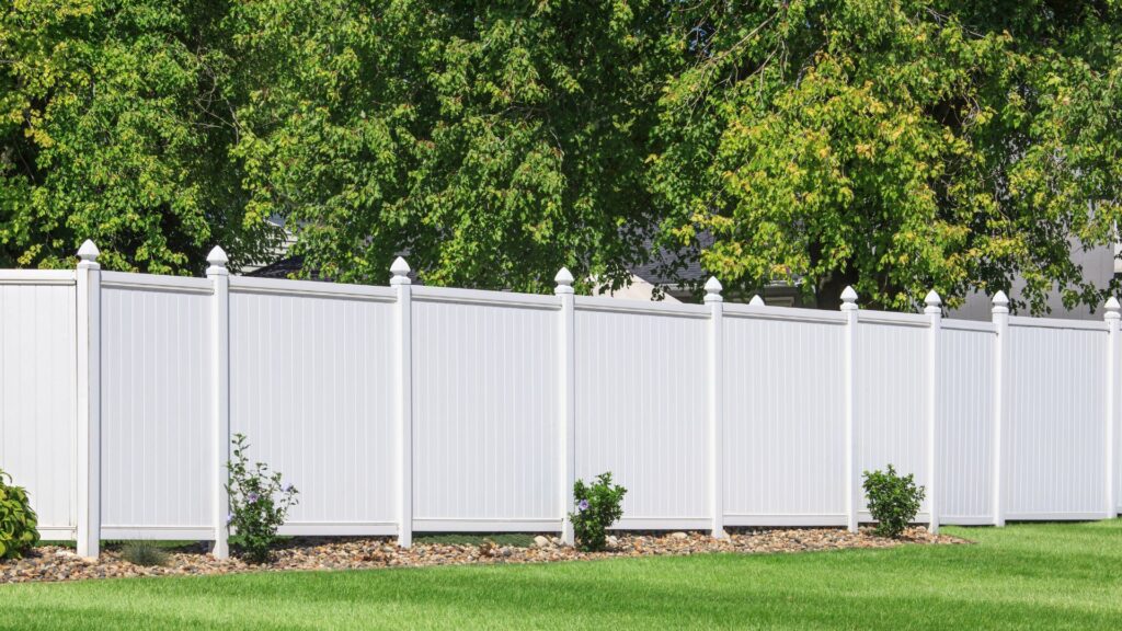 A long white vinyl fence.